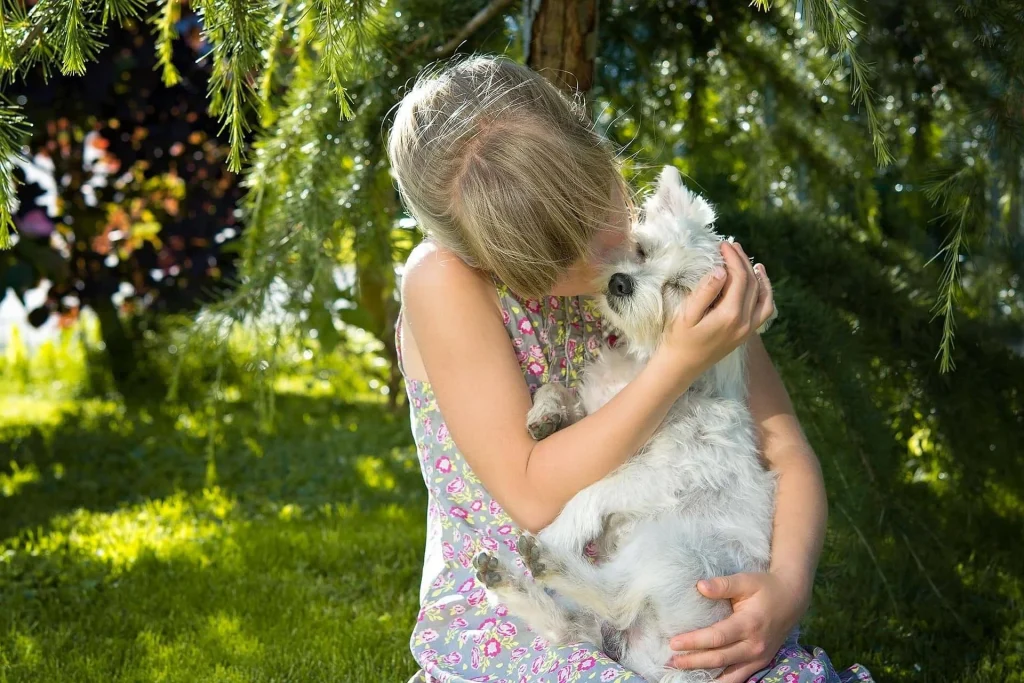 Cute Girl with Dog In the garden